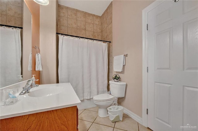 103 Gardenia St Unit 3, South Padre Island, TX 78597 - bathroom featuring tile patterned flooring, toilet, vanity, baseboards, and curtained shower