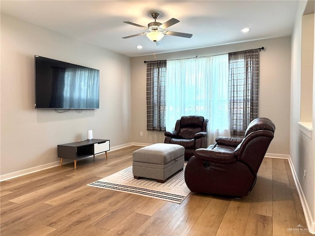 living room featuring ceiling fan and light wood-type flooring