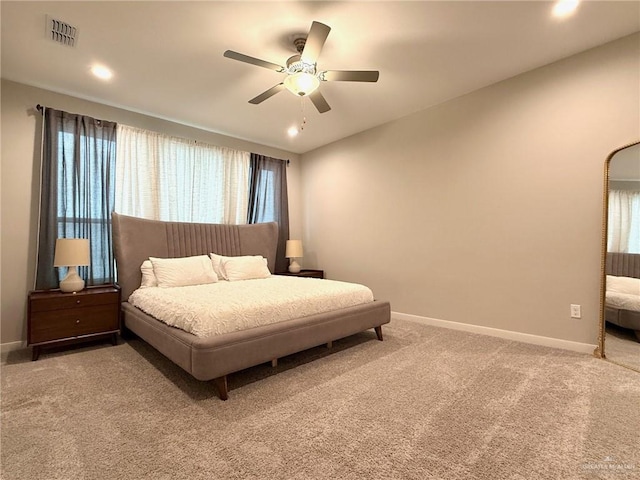 bedroom featuring multiple windows, carpet floors, and ceiling fan