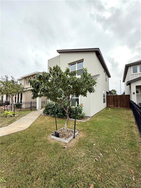 view of side of property with a lawn