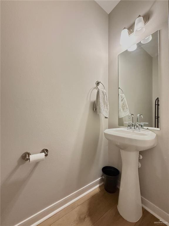 bathroom with hardwood / wood-style floors