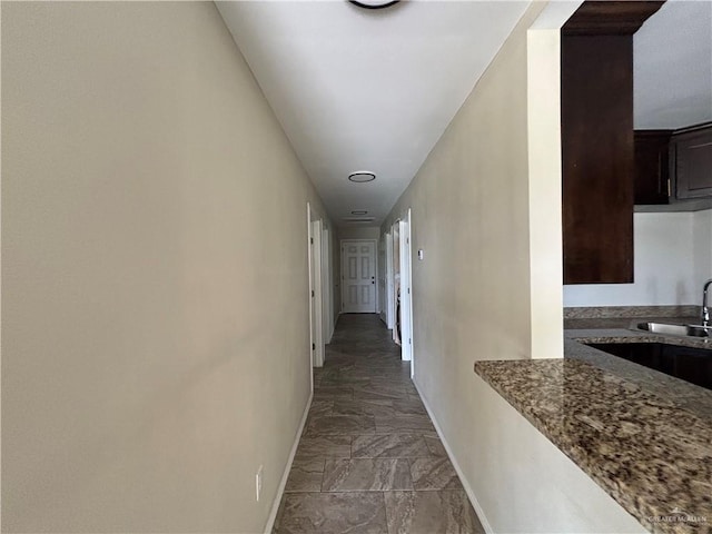 7609 Charlie Boy St, Mission, TX 78574 - hall with baseboards, marble look tile flooring, and a sink
