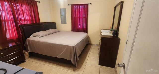 bedroom featuring electric panel and light tile patterned floors