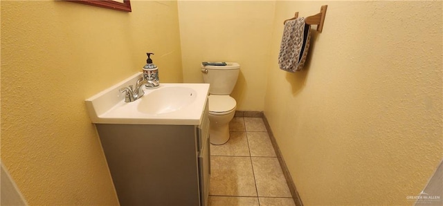 bathroom featuring tile patterned floors, vanity, and toilet