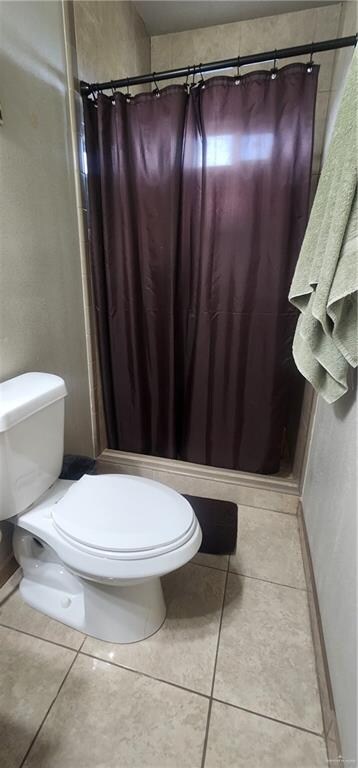 bathroom with tile patterned flooring and toilet