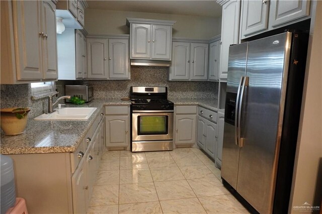 kitchen with gray cabinets and appliances with stainless steel finishes