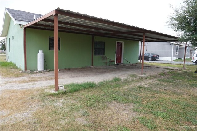 rear view of property featuring a carport