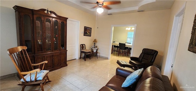 sitting room featuring light tile patterned floors and ceiling fan with notable chandelier