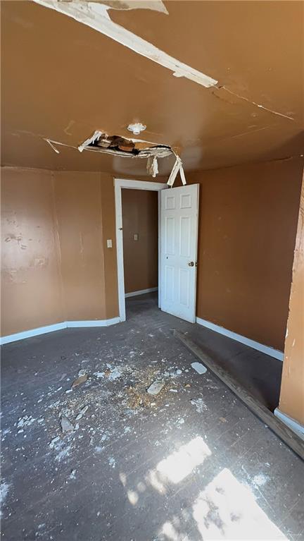 spare room featuring baseboards