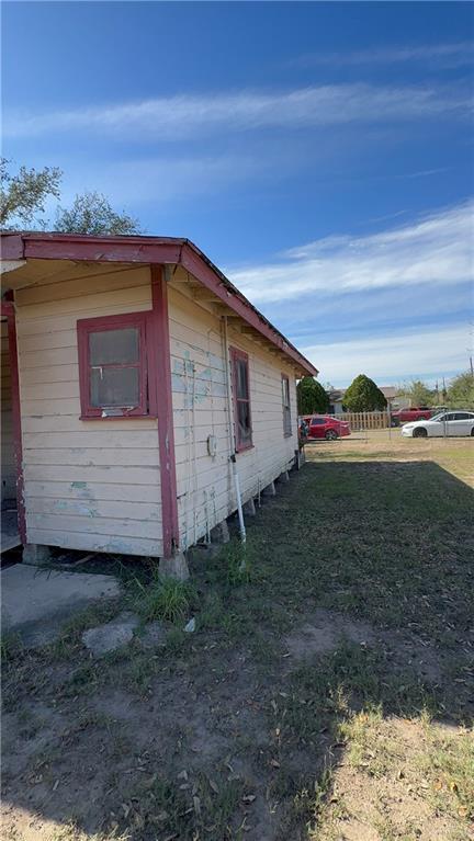 view of side of property with a yard and fence