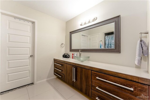 bathroom featuring tile patterned flooring, vanity, and baseboards