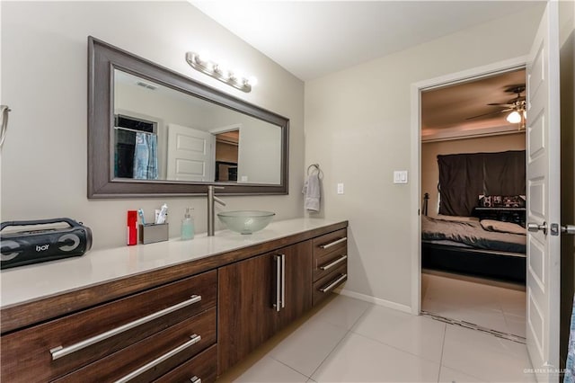 full bath with ensuite bathroom, tile patterned flooring, visible vents, vanity, and baseboards