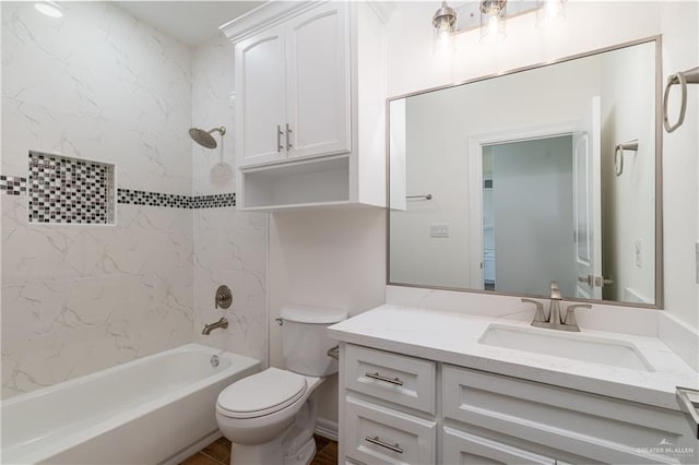 full bathroom featuring tiled shower / bath combo, vanity, and toilet