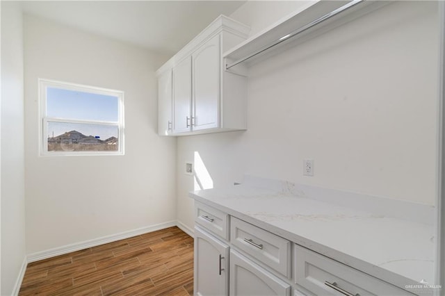 clothes washing area featuring cabinets and hookup for a washing machine