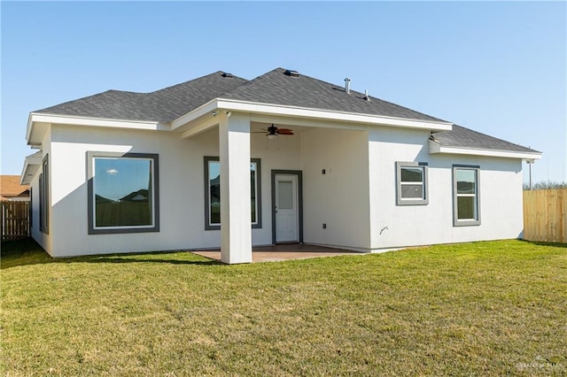 back of house featuring a patio area, ceiling fan, and a lawn