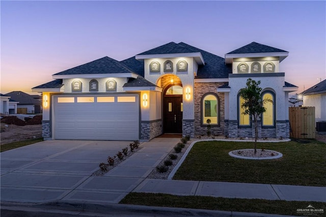 view of front of property featuring a garage and a yard