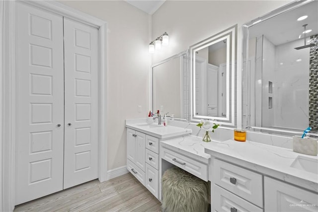 bathroom with a shower, wood-type flooring, and vanity