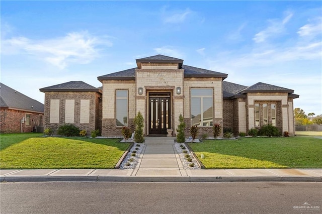 view of front of property with central air condition unit and a front yard