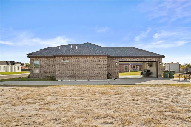 1110 Raptor St, Palmview, TX 78572 - back of house featuring brick siding, roof with shingles, and an attached garage