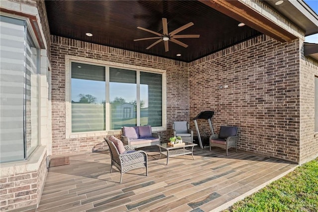 wooden terrace featuring ceiling fan and an outdoor hangout area