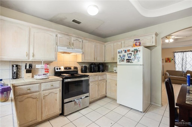 kitchen with backsplash, ceiling fan, electric stove, white refrigerator, and tile countertops