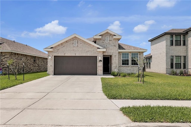 view of front of home with a front yard and a garage