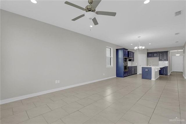 unfurnished living room with light tile patterned floors, ceiling fan with notable chandelier, and sink