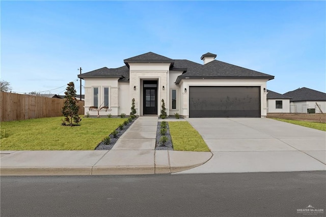 view of front facade with a front yard and a garage