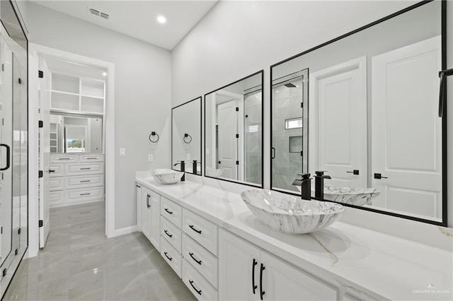 bathroom with vanity and a shower with shower door