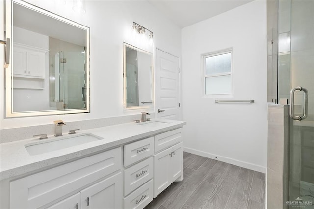 bathroom featuring a sink, a shower stall, and double vanity