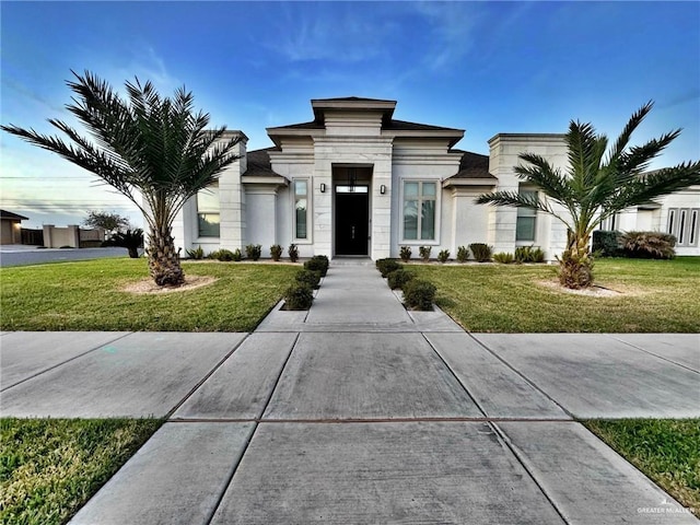 view of front of house featuring a front yard and stucco siding