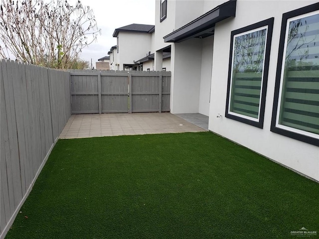 view of yard featuring a patio area and a fenced backyard