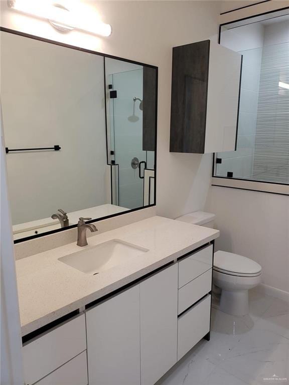 full bathroom featuring vanity, toilet, a stall shower, and marble finish floor