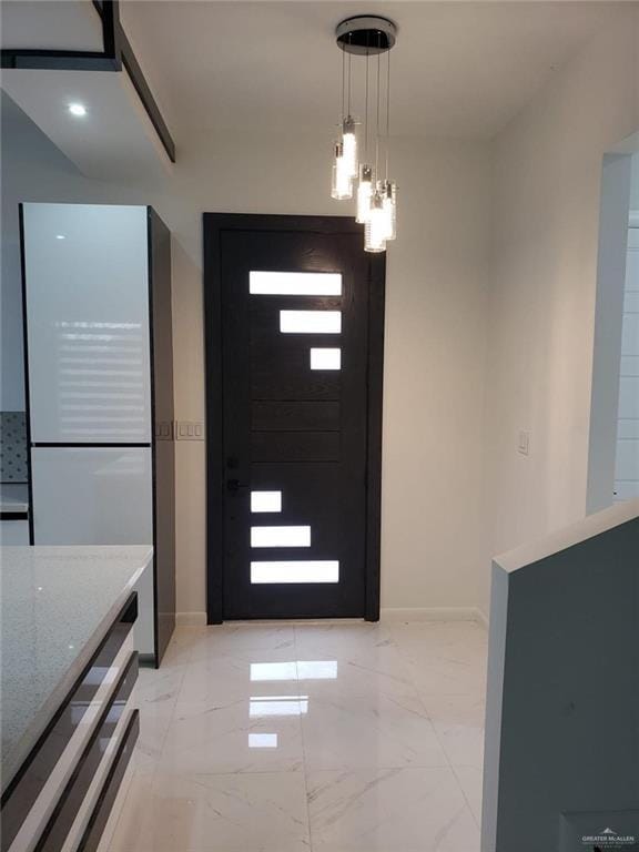 foyer entrance with baseboards and marble finish floor