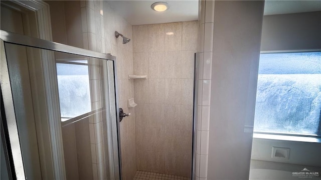 bathroom with a shower with door