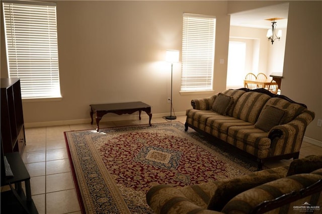 tiled living room featuring an inviting chandelier