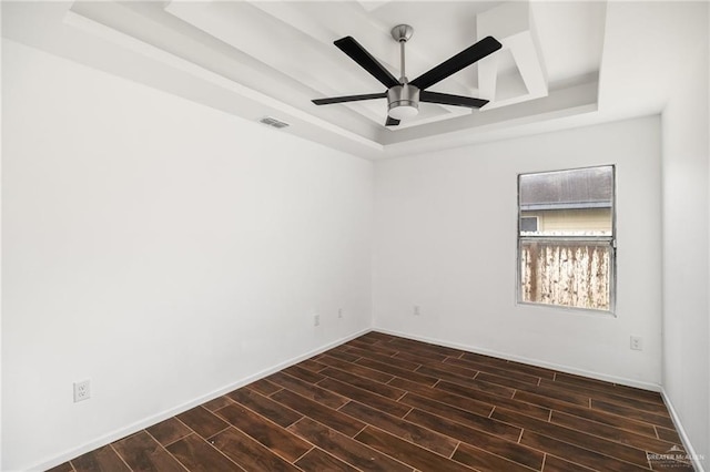 unfurnished room featuring ceiling fan and a raised ceiling