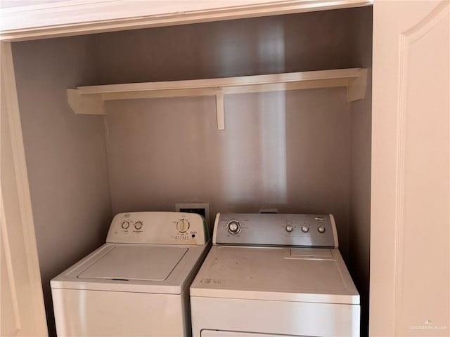 clothes washing area with separate washer and dryer