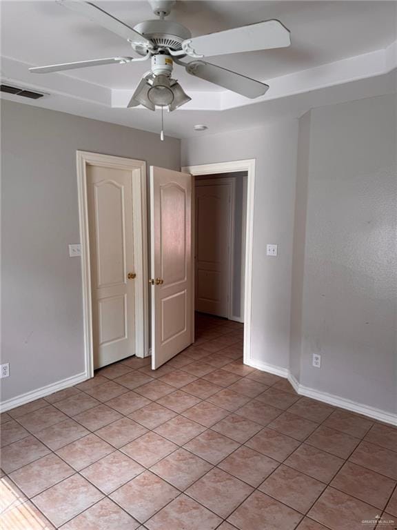 spare room featuring ceiling fan and light tile patterned floors