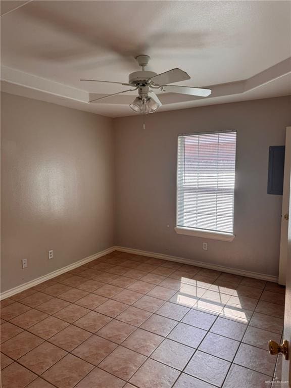 tiled spare room featuring ceiling fan