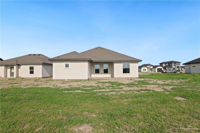 2005 Lime St, San Juan, TX 78589 - back of property featuring a lawn and stucco siding