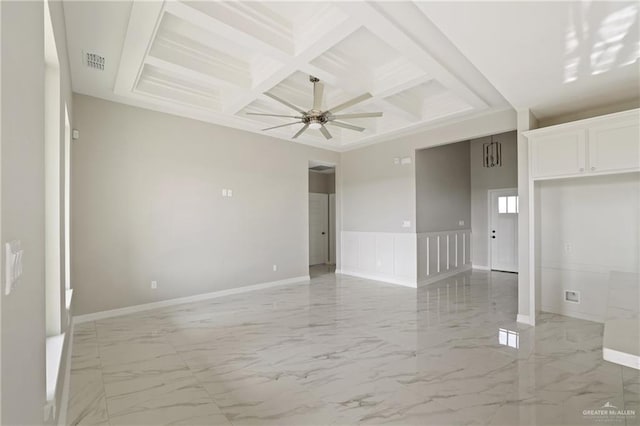 2005 Lime St, San Juan, TX 78589 - empty room featuring coffered ceiling, light marble finish floors, beamed ceiling, a ceiling fan, and baseboards