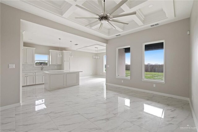 2005 Lime St, San Juan, TX 78589 - unfurnished living room featuring light marble finish flooring, baseboards, coffered ceiling, ceiling fan, and beam ceiling