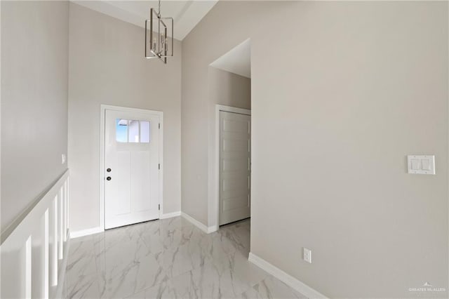 2005 Lime St, San Juan, TX 78589 - foyer entrance featuring light marble finish flooring, a chandelier, and baseboards
