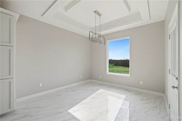 2005 Lime St, San Juan, TX 78589 - empty room with light marble finish floors, baseboards, a raised ceiling, and a chandelier