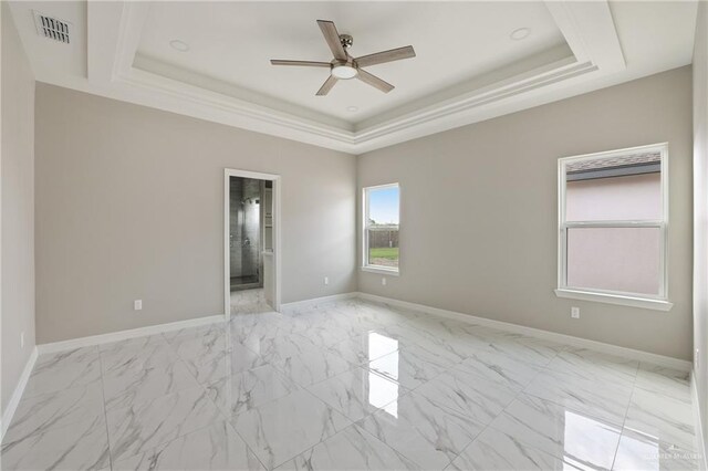 2005 Lime St, San Juan, TX 78589 - empty room featuring a tray ceiling, a ceiling fan, light marble finish flooring, and baseboards