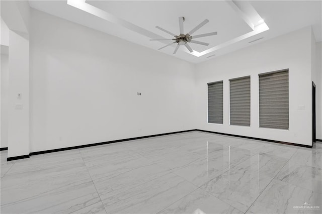 4120 Wisteria Ave, Mcallen, TX 78504 - empty room with a ceiling fan, a raised ceiling, and baseboards