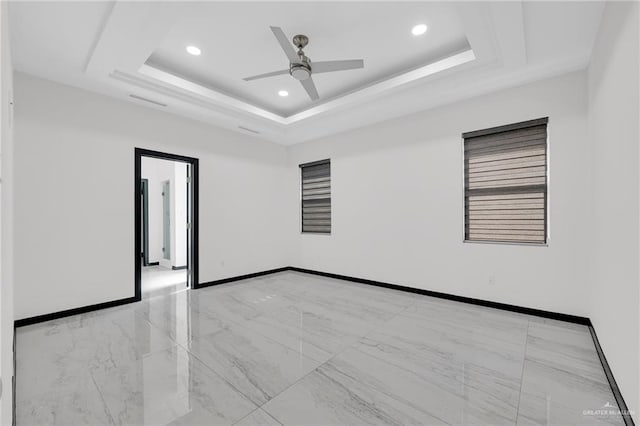 4120 Wisteria Ave, Mcallen, TX 78504 - empty room with light marble finish flooring, recessed lighting, a ceiling fan, baseboards, and a tray ceiling