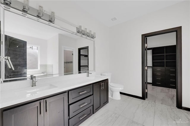 4120 Wisteria Ave, Mcallen, TX 78504 - bathroom featuring marble look tile flooring, double vanity, and toilet