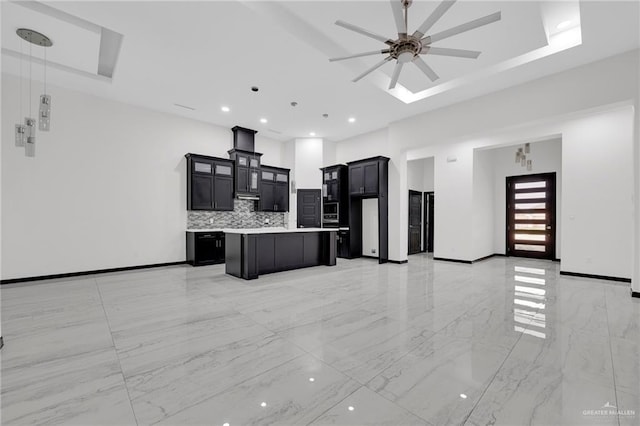 4120 Wisteria Ave, Mcallen, TX 78504 - kitchen with a kitchen island, a ceiling fan, backsplash, light countertops, and light marble finish floors